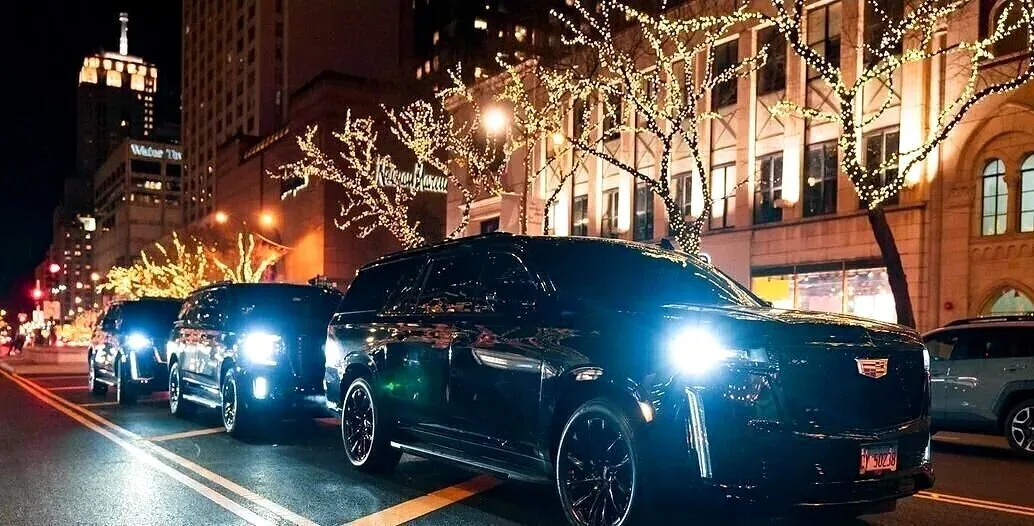 Monarch Fleet Escalades on Michigan Avenue under holiday lights