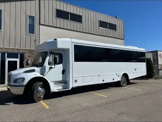 30-passenger limo bus exterior at night